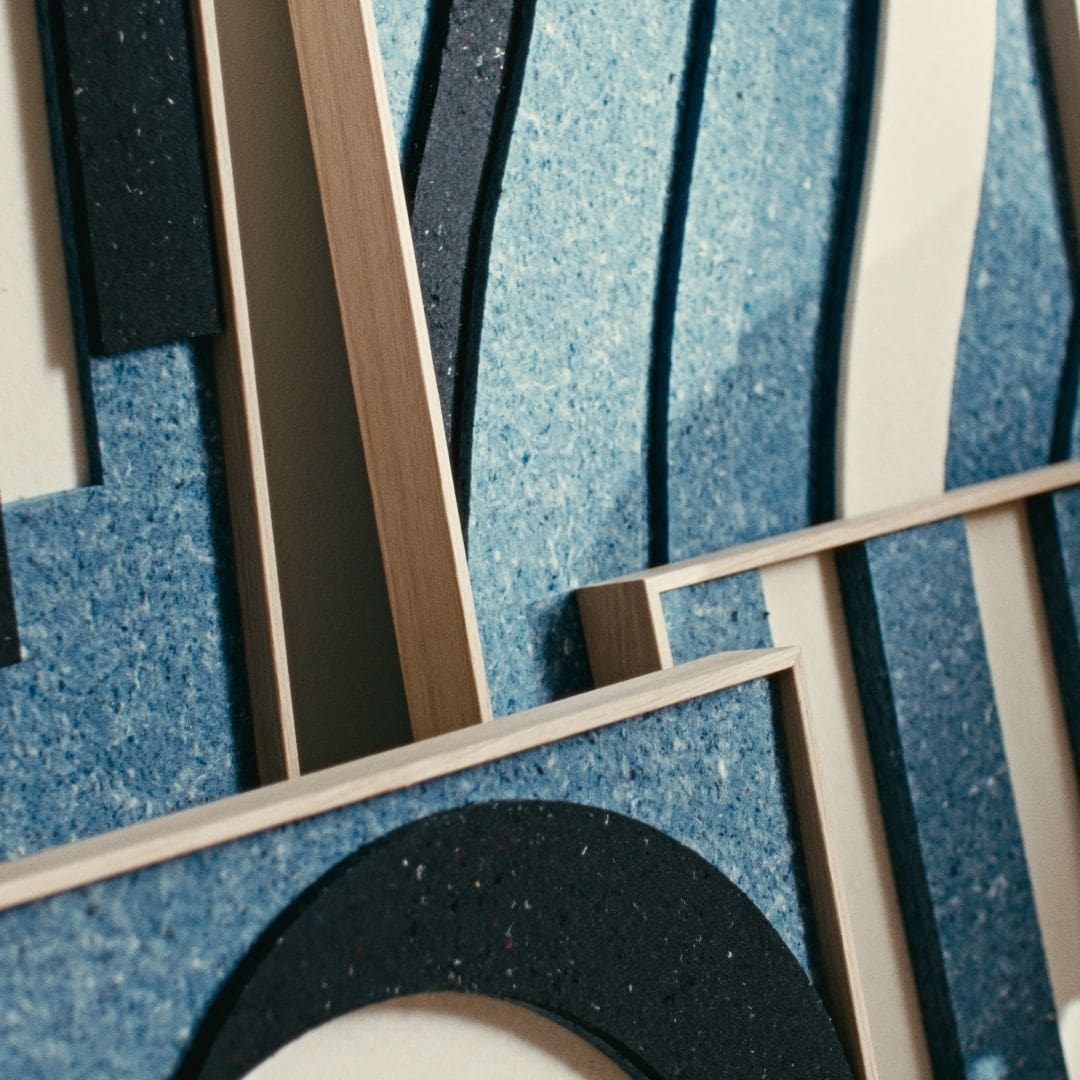 Close-up of original modern art panels in blue with oak frames, showcasing layered textures and sustainable design elements.